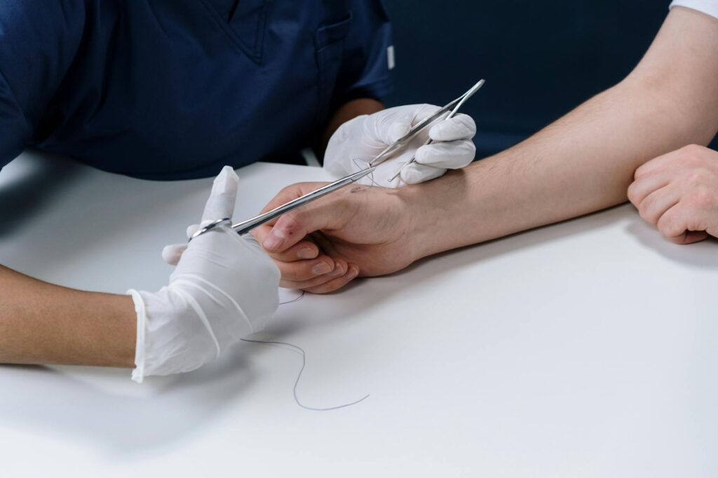 A close-up of a dog bite wound on a person's arm, with medical documentation in the background. — file a dog bite claim