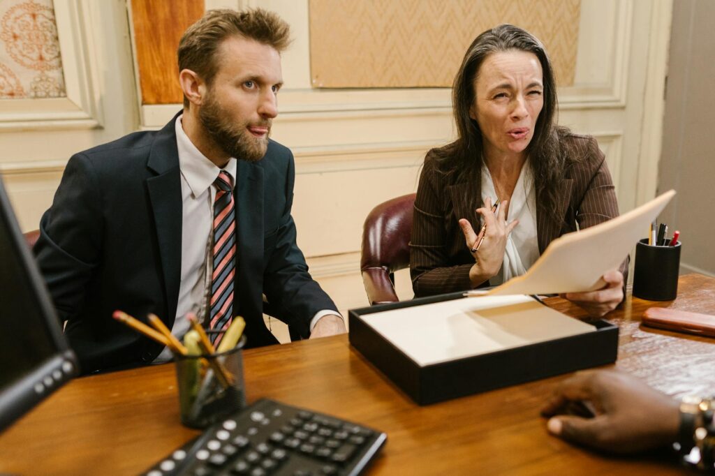 A lawyer advising a client on injury compensation issues in a meeting. — injury claim delayed