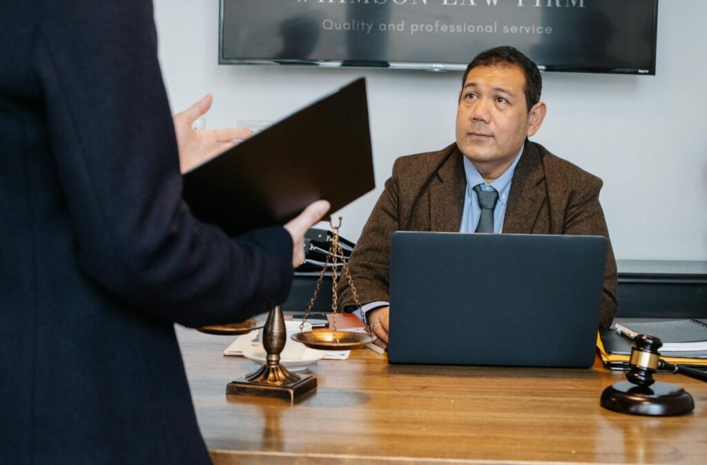 A professional dog bite attorney discussing a case with a client in an office setting. — file a dog bite claim