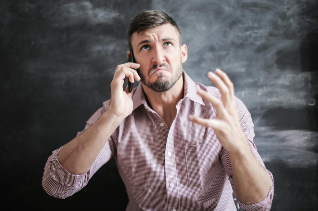 An image of a stressed individual on the phone, symbolizing frustration with claim delays. — injury claim delayed