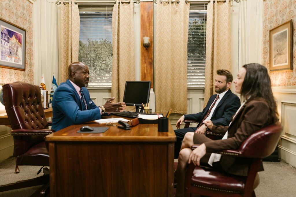 A lawyer meeting with a client to discuss an injury claim. — do I need a lawyer for injury claim