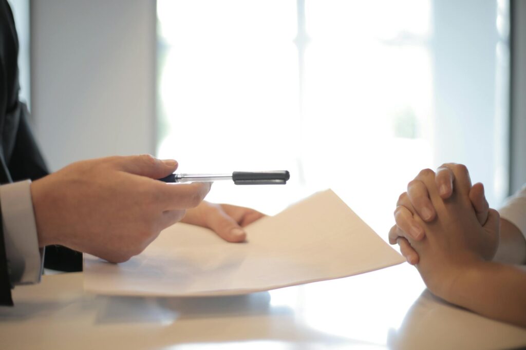 A photo depicting a negotiation meeting between a claimant and an insurance adjuster — injury claim process