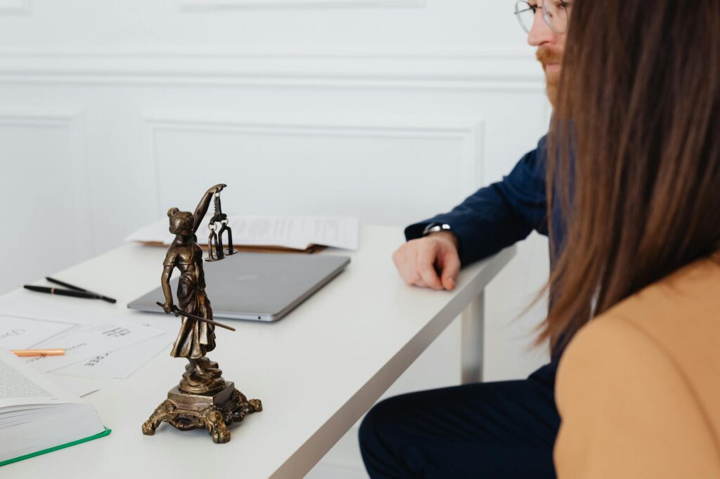 An image depicting a person consulting with a legal professional about their injury claim. — injury claim mistakes