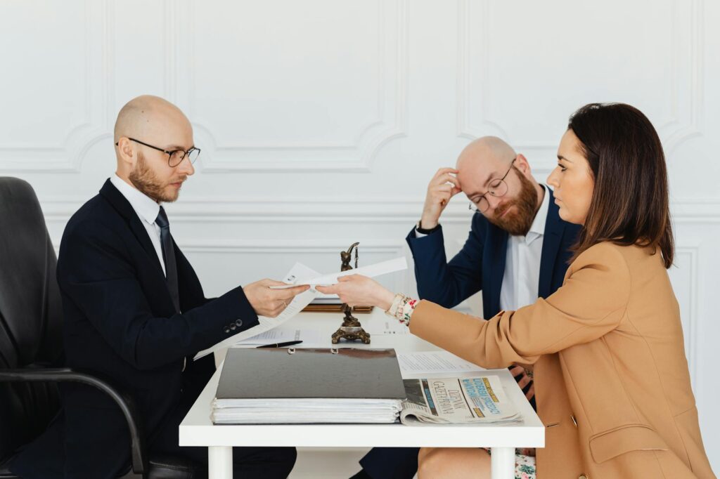 Image of a negotiation meeting between clients and attorneys discussing pain and suffering calculation
