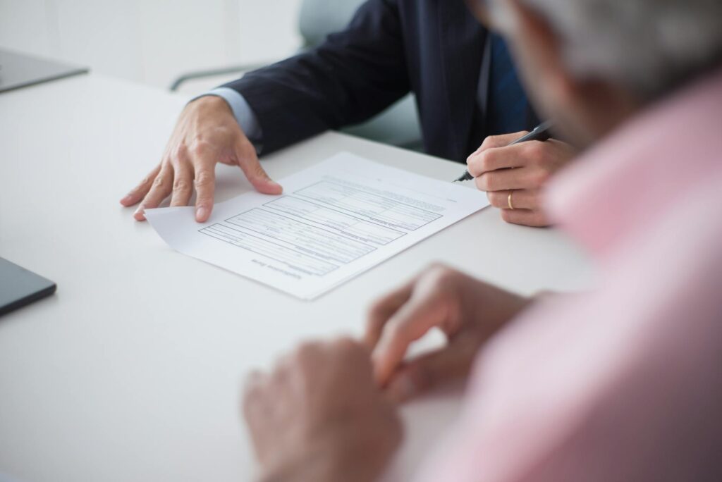 Photo of a person consulting with a legal professional about their medical bills — medical bills injury claim