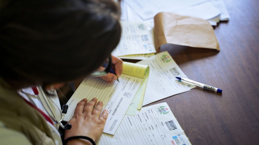 A person organizing their medical documentation at a desk — medical documentation injury claims