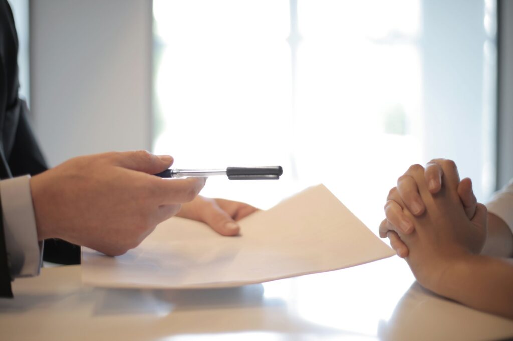 A photo of a negotiation meeting between a claimant and an insurance adjuster related to factors affecting injury claim settlement