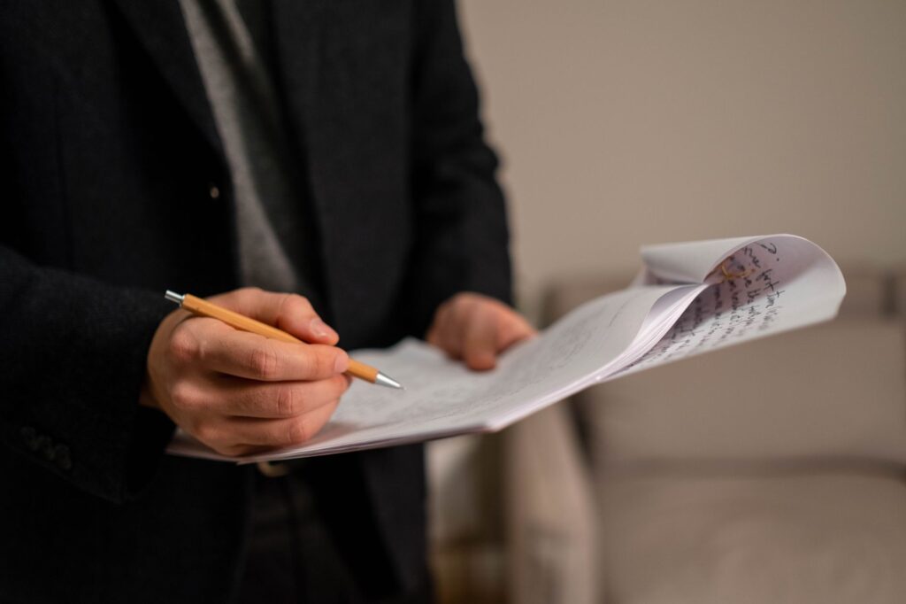 An image of a person documenting their pain and suffering in a journal, illustrating the process of preparing for pain and suffering claims.