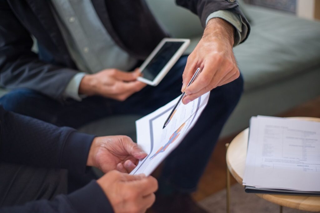 An image of a professional negotiation setting, depicting a discussion between a claimant and an insurance adjuster, incorporating injury claim negotiation tips for effective outcomes.