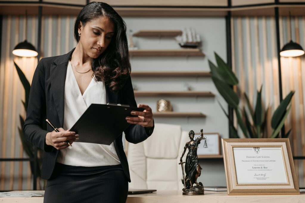 An image showing a person reviewing their injury claim paperwork with a lawyer. — hiring a lawyer injury claim