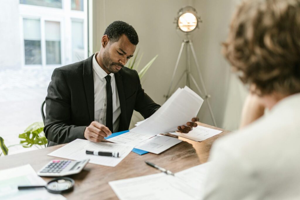 Image of a financial planner discussing future medical expenses calculation with a client