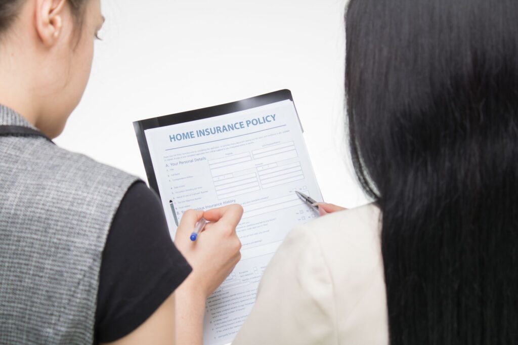 Image of a person discussing claims with an insurance adjuster — after filing an injury claim