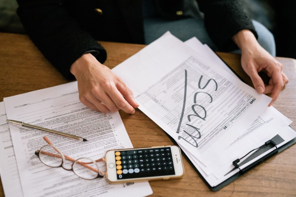 A person reviewing injury claim documents with a calculator and pen, symbolizing preparation for negotiation. — negotiat…