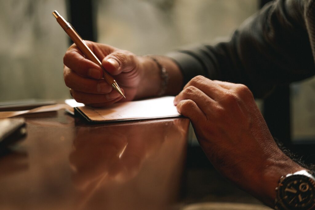 A photo of a person writing an appeal letter with a thoughtful expression. — appeal low injury settlement