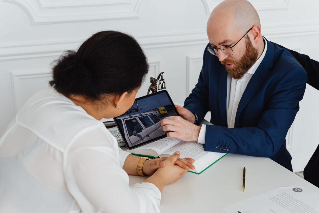 An image depicting a person consulting with a lawyer about their claim, highlighting mistakes using injury claim calculator