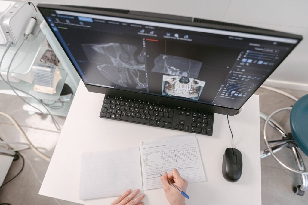 An image of medical records being reviewed for an injury claim. — factors affecting injury claim settlement