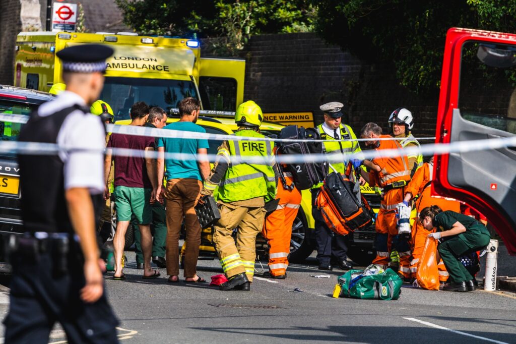 Image of a car accident scene with emergency services responding — after accident steps claim