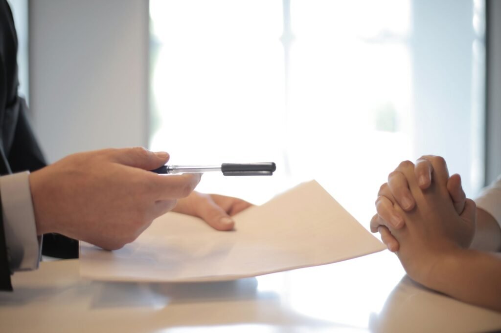 A photograph of a negotiation meeting between an individual and an insurance adjuster, illustrating the factors affecting injury settlement.