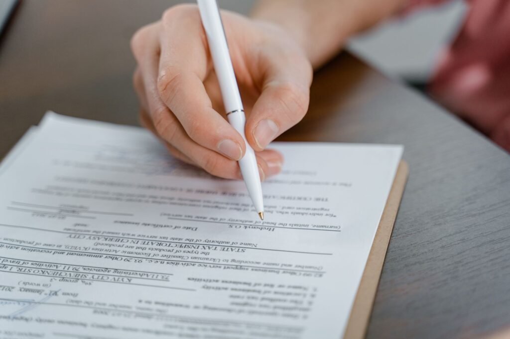 An image depicting a person filling out injury claim paperwork. — filing an injury claim