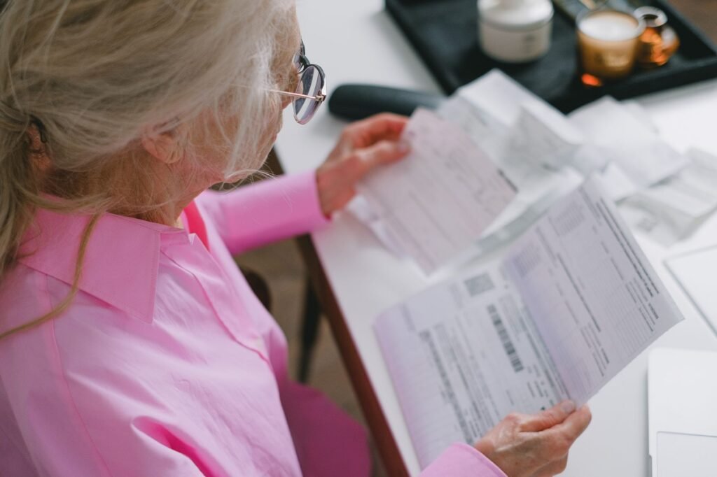 An image of a person reviewing medical bills and documentation for their injury claim. — mistakes using injury claim cal…