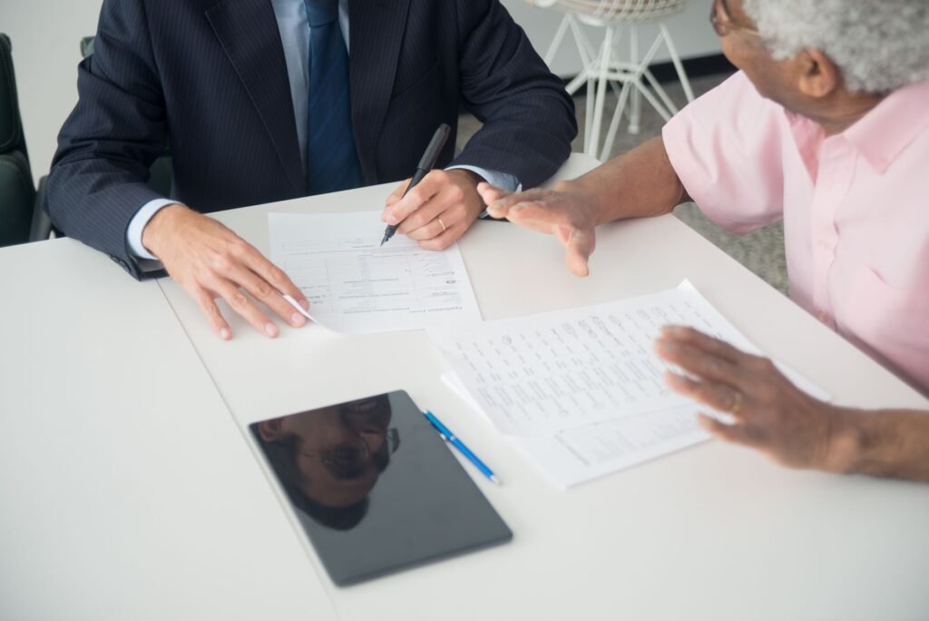 A photo of a meeting between a claimant and an insurance adjuster discussing an insurance adjuster injury claim