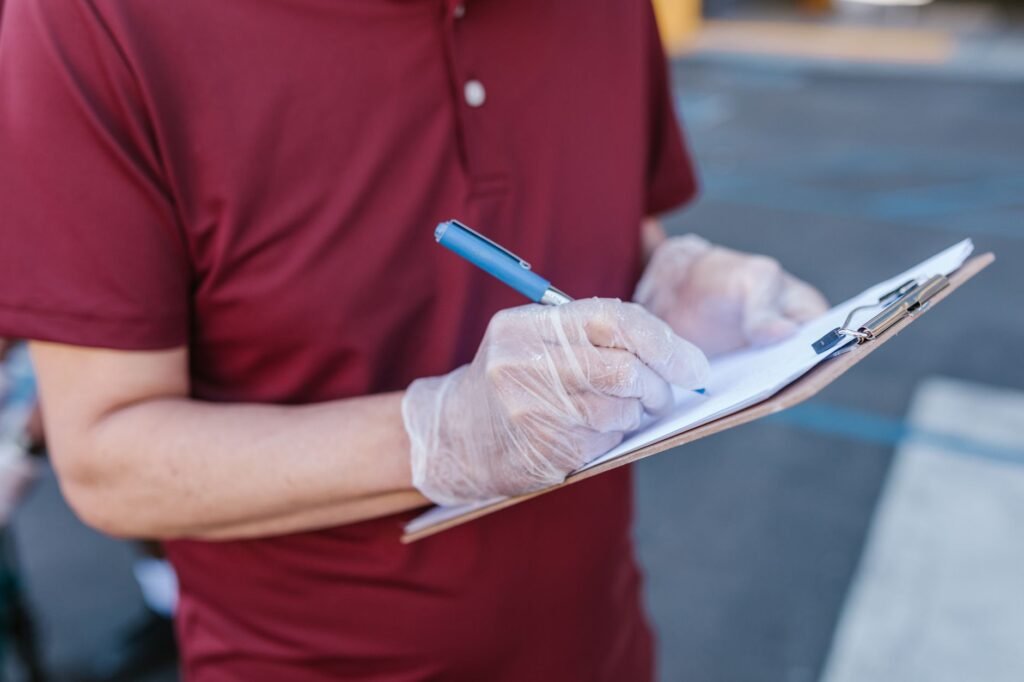 A photo showing a person taking notes about their injuries and documenting for claim purposes. — Document Injuries for C…