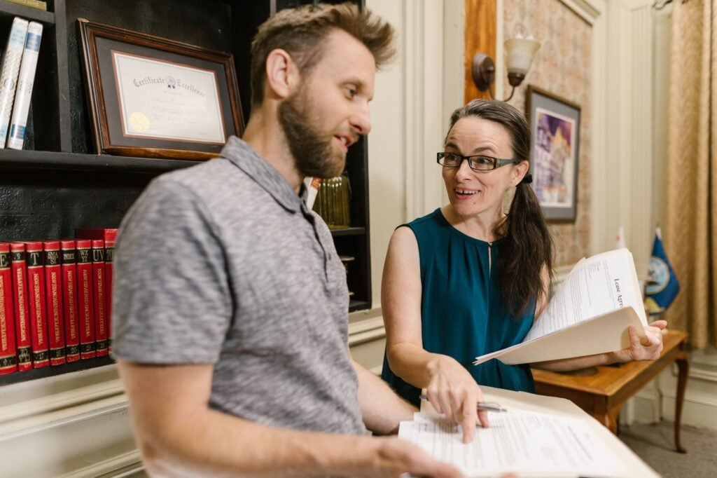 A professional discussing medical documentation with a client in a law office setting. — medical records injury claim