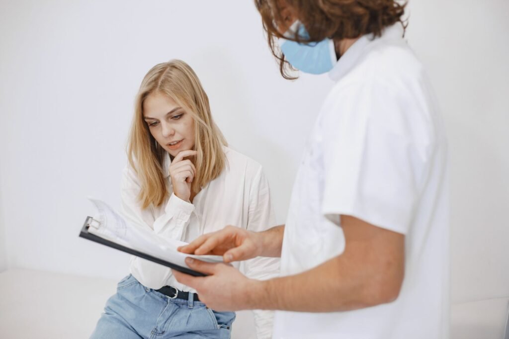 An image of a healthcare professional discussing medical records with a patient. — medical records injury claim
