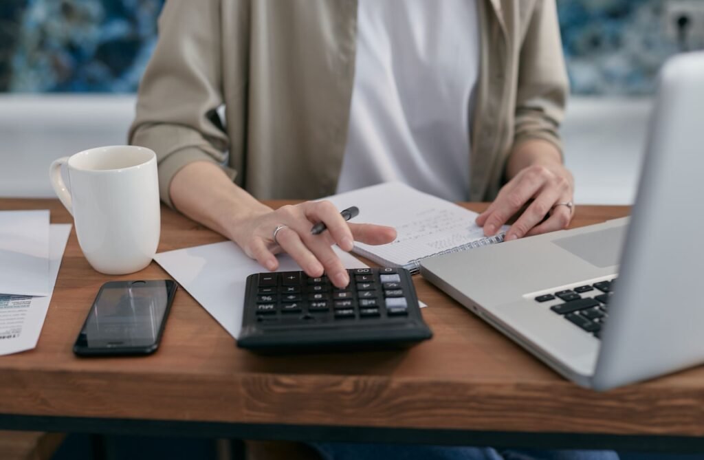 Photo of a person using a laptop to calculate their injury claim. — injury claim calculator car accident
