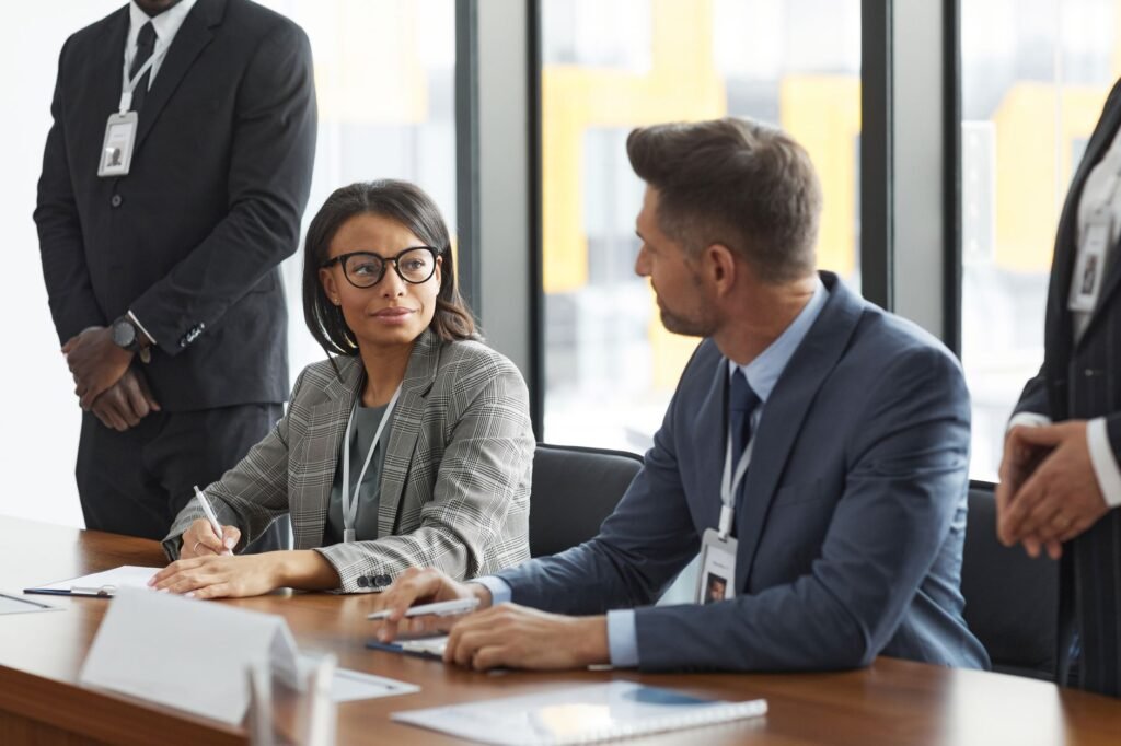 A negotiator discussing terms with a claimant in a professional setting. — insurance adjuster role